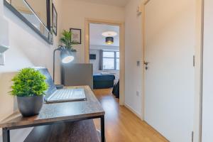 a room with a desk with a laptop on it at City Skyline View Studio Apartment - Birmingham Central in Birmingham
