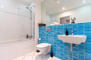 a bathroom with a toilet and a sink and a tub at City Skyline View Studio Apartment - Birmingham Central in Birmingham