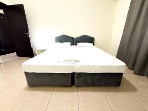 a large bed in a room with at Nahda Star Residence - Home Stay in Dubai