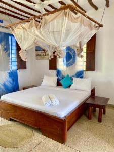een slaapkamer met een bed met twee handdoeken erop bij White Star Ocean View Hotel in Paje