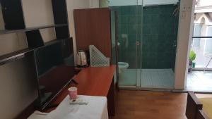 une salle de bain avec une douche avec une porte vitrée dans l'établissement Guest House THANH, à Hô-Chi-Minh-Ville 4 autres photos