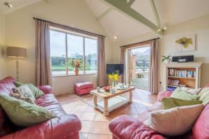 a living room with a couch and a table at The Cart Lodge 6 in Great Massingham