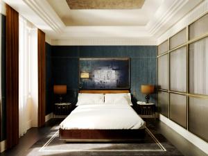 a bedroom with a bed and two tables with lamps at Hotel Lord Byron - Small Luxury Hotels of the World in Rome