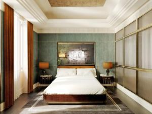a bedroom with a bed and two tables with lamps at Hotel Lord Byron - Small Luxury Hotels of the World in Rome