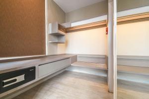 an empty room with wooden floors and shelves in a room at PlayStaytion Damansara by RBNB in Damansara Perdana