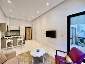 Chez Dadou - joli Apt Marsa Safsaf في المرسى: غرفة معيشة مع أريكة وطاولة