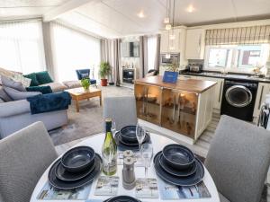 a kitchen and living room with a table and chairs at A and C Lodge in Carlisle