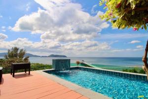 a swimming pool with a view of the ocean at Luxury Rooftop Penthouse in Ban Nakhale