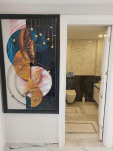 a picture of a bathroom with a painting on the wall at Casa Hills in Alanya