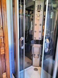 a small machine in a room with a glass door at Scirocco Eolie with sea view! in Lipari