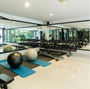 a gym with a lot of exercise balls and weights at Luxury Rooftop Penthouse in Ban Nakhale