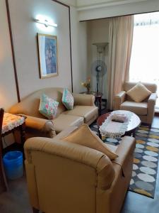 a living room with couches and a table at Fantastic appartment at times square Kuala Lumpur in Kuala Lumpur