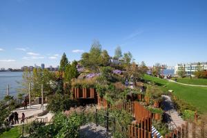 a garden with flowers on a hill next to the water at Chelsea 1br w doorman elevator nr High Line NYC-601 in New York