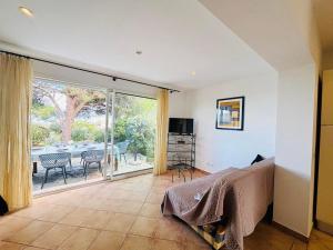 a bedroom with a bed and a view of a patio at Appartement Boug 26 Lumio in Lumio