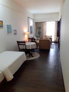 a bedroom with a bed and a living room with a table at Fantastic appartment at times square Kuala Lumpur in Kuala Lumpur