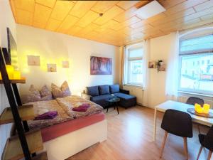 a room with a bed and a couch and a table at R2 - Urlaubsmagie - 5 Fussminuten zur Elbe, Pool in Rathmannsdorf +26 photos