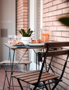 a table with a plate of pastries on it at Suite 52 Trastevere in Rome