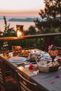 a table with plates of food on it with a view at Faralia Hotel in Faralya