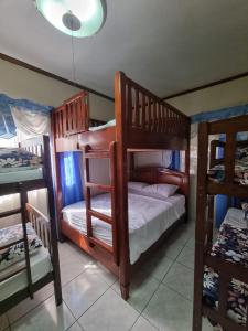 a bedroom with two bunk beds and a ceiling at Aikaterinis in San Narciso