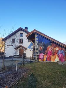 a building with a mural on the side of it at Hostal Rural Iratiko Urkixokoa in Orbaiceta