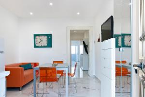 a living room with a table and a couch at Balcone Caboto in Torre Lapillo