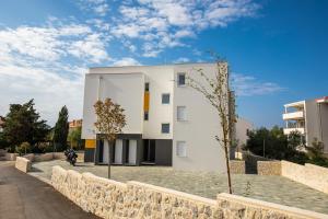 a white building on the side of a street at Luxury Apartment Marija in Novalja