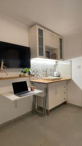 a kitchen with a desk with a laptop on it at Spring-shell in Beer Sheva