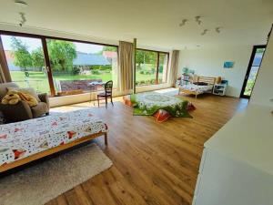 a living room with a bed and a couch at Sweet Valley View - Architectenwoning in Zutendaal