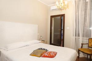 a bedroom with a bed with two pillows on it at Saint Charles Apartment in Bologna