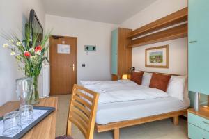 Postel nebo postele na pokoji v ubytování Hotel Martinelli