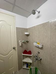 a bathroom with a shower and a sink and a mirror at Sri Sai 3 BHK Home in Kelambākkam