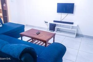 a living room with a blue couch and a coffee table at 1 bedroom with 2 beds, Mombasa Kisimani, Nyali in Mombasa