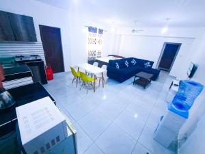 a living room with a blue couch and a table at 1 bedroom with 2 beds, Mombasa Kisimani, Nyali in Mombasa