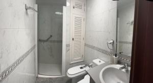 a bathroom with a sink and a shower and a toilet at Playa Chica apartment in Puerto del Carmen