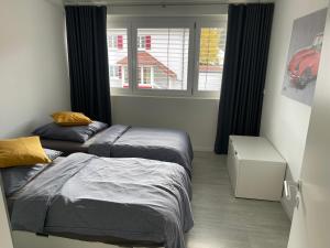 a bedroom with two beds and a window at Amt11 - Relax / family / home-office in Bad Wörishofen