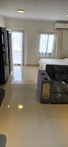 een grote slaapkamer met een bed en een bank bij New house in Sharm El Sheikh