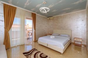 a bedroom with a bed and a room with a window at Ani Lux in Dobra Voda +18 photos
