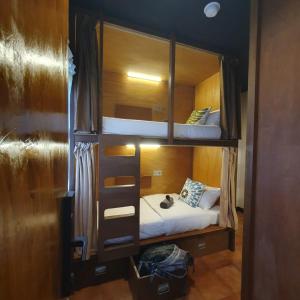 a couple of bunk beds in a room at Kartika Lodge in Bengkok