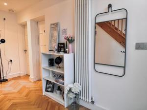 a mirror hanging on a wall in a room at En-suites and Rooms Near Wembley Stadium in London