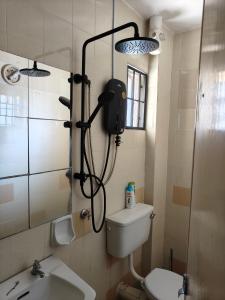a shower in a bathroom with a toilet and a sink at NAHARA HOMESTAY Carlina in Petaling Jaya +16 photos