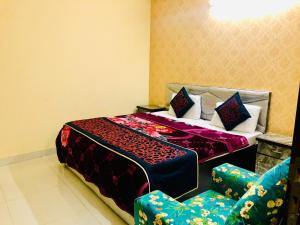 a bedroom with a bed and two chairs in it at 2BHK Independent Service Apart with Lift in Vasant Kunj New Delhi in New Delhi