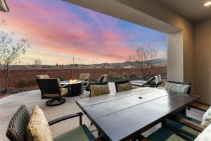 a patio with a table and chairs and a large window at Desert Moose #75 townhouse in Santa Clara