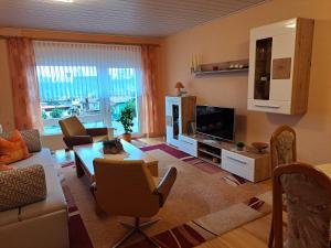 a living room with a couch and a table at Ferienwohnung Familie Windt in Feldberg