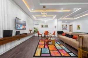 a living room with a couch and a tv at Frotech property in Lekki