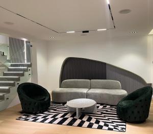 a living room with a couch and two chairs at Frotech property in Lekki