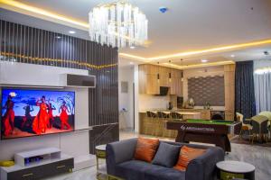 a living room with a tv and a pool table at Frotech property in Lekki