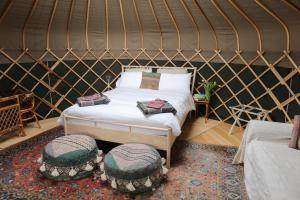 a bedroom with a bed in a yurt at Black Pig Retreats Luxury Glamping in Shaftesbury