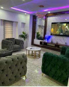 a living room with couches and a flat screen tv at Frotech property in Lekki