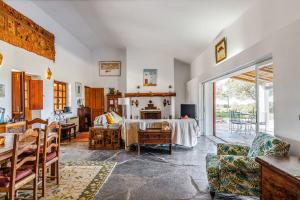 a living room with a table and chairs and a room at Casa do Mar in Sesimbra