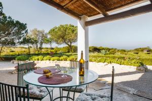 a table with a bottle of wine on a patio at Casa do Mar in Sesimbra